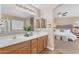 En-suite bathroom boasts double sinks, a large mirror, and access to the main bedroom at 29368 N Red Finch Dr, San Tan Valley, AZ 85143