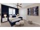 This bedroom is cozy with blue accents, complementing the neutral walls and carpet at 29368 N Red Finch Dr, San Tan Valley, AZ 85143