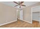 Bright bedroom featuring wood floors, a ceiling fan, and neutral color palette at 29368 N Red Finch Dr, San Tan Valley, AZ 85143
