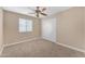 Bedroom with carpeted floor features a sliding closet door, a ceiling fan, and a window with blinds at 29368 N Red Finch Dr, San Tan Valley, AZ 85143