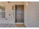 Elegant front door with sidelight window and a welcoming doormat on a covered porch at 29368 N Red Finch Dr, San Tan Valley, AZ 85143