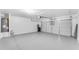 Spacious garage painted in shades of gray features a water heater, water softener and automatic garage door opener at 29368 N Red Finch Dr, San Tan Valley, AZ 85143