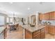 Open kitchen with island bar seating, flowing into the dining and living spaces at 29368 N Red Finch Dr, San Tan Valley, AZ 85143