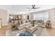 Inviting living room with a large sectional sofa and a view into the modern kitchen at 29368 N Red Finch Dr, San Tan Valley, AZ 85143