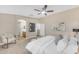 Bright main bedroom showcasing a ceiling fan, an arched entry, and an en-suite bathroom at 29368 N Red Finch Dr, San Tan Valley, AZ 85143