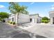 View of single story home with two car garage, manicured lawn, and lovely desert landscaping at 295 N Rural Rd # 133, Chandler, AZ 85226