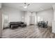 Bright living room featuring hardwood floors, a black leather couch and a view of the dining area at 295 N Rural Rd # 133, Chandler, AZ 85226