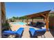 Outdoor oasis featuring a pristine pool, relaxing lounge chairs, and a covered patio at 3088 E Andre Ave, Gilbert, AZ 85298