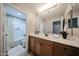 Well-lit bathroom with a large mirror, vanity, and shower with bathtub at 3088 E Andre Ave, Gilbert, AZ 85298