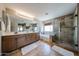 Bathroom featuring dual sinks, a walk-in shower, and a separate bathtub at 3088 E Andre Ave, Gilbert, AZ 85298