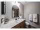 Bathroom featuring wood vanity with granite countertop, decorative mirror, tiled shower and neutral color scheme at 3088 E Andre Ave, Gilbert, AZ 85298