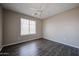 Bedroom featuring a large window, ceiling fan, and wood-look floors at 3088 E Andre Ave, Gilbert, AZ 85298