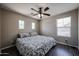 Comfortable bedroom features a ceiling fan, two windows, and neutral walls at 3088 E Andre Ave, Gilbert, AZ 85298