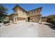 Beige two-story home with a tile roof, a three-car garage, and low-maintenance desert landscaping at 3088 E Andre Ave, Gilbert, AZ 85298