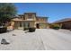 Two-story home featuring desert landscaping, tile roof, and a long driveway leading to a two-car garage at 3088 E Andre Ave, Gilbert, AZ 85298
