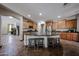 Spacious kitchen with a central island featuring bar stool seating, wooden cabinets, and an open layout at 3088 E Andre Ave, Gilbert, AZ 85298