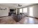 Cozy living room featuring a plush gray sectional sofa and large-screen television for ultimate relaxation at 3088 E Andre Ave, Gilbert, AZ 85298