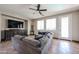 Inviting living room featuring a comfortable sofa, a media console, and large windows for natural light at 3088 E Andre Ave, Gilbert, AZ 85298