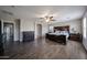 Main bedroom with wood floors, ceiling fan, and elegant furnishings at 3088 E Andre Ave, Gilbert, AZ 85298