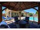 Inviting covered patio with cozy seating area and view of the sparkling pool at 3088 E Andre Ave, Gilbert, AZ 85298