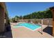 Private backyard pool with rock accents and mature landscaping, perfect for relaxation at 3088 E Andre Ave, Gilbert, AZ 85298