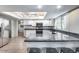 Modern kitchen featuring granite countertops, stainless steel appliances, and bright white cabinetry at 3102 W Betty Elyse Ln, Phoenix, AZ 85053