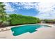 Inviting backyard pool with lush green privacy hedge, perfect for relaxation and outdoor enjoyment at 3102 W Betty Elyse Ln, Phoenix, AZ 85053