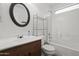 Well-lit bathroom featuring a single sink vanity, tiled shower, and chrome fixtures at 3114 E Kristal Way, Phoenix, AZ 85050
