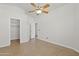 Open bedroom with tile flooring, ceiling fan and adjacent walk-in closet at 3114 E Kristal Way, Phoenix, AZ 85050