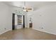 Spacious bedroom with tile flooring, a ceiling fan, window, and ensuite bathroom at 3114 E Kristal Way, Phoenix, AZ 85050