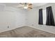 Cozy bedroom with neutral carpet, white trim, and a double door closet, creating a comfortable space at 3114 E Kristal Way, Phoenix, AZ 85050