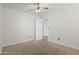 A bedroom featuring neutral carpeting, a ceiling fan, and a white door at 3114 E Kristal Way, Phoenix, AZ 85050