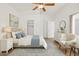 Bright bedroom featuring a ceiling fan, a blue accent rug, a comfy chair, and lots of natural light at 3114 E Kristal Way, Phoenix, AZ 85050