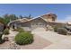 Street view of a beige single-story home with a two-car garage and low maintenance desert landscaping at 3114 E Kristal Way, Phoenix, AZ 85050