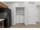 A laundry area with a washer and dryer, in a closet adjacent to the kitchen area at 3114 E Kristal Way, Phoenix, AZ 85050