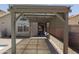 Covered patio with brick pavers, offering shade and a view of the pool and backyard at 3114 E Kristal Way, Phoenix, AZ 85050