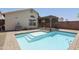Backyard pool with a Baja step and covered patio, surrounded by brick pavers and a block wall at 3114 E Kristal Way, Phoenix, AZ 85050