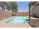 Sparkling pool surrounded by a brick patio and lush greenery, providing a private backyard oasis at 3114 E Kristal Way, Phoenix, AZ 85050