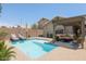A backyard with a refreshing private pool, patio seating, and a brick privacy wall at 3114 E Kristal Way, Phoenix, AZ 85050