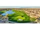 Breathtaking aerial view of the golf course community, showcasing the homes, lush greenery, water features, and mountain backdrop at 36172 N Secret Garden Path, Queen Creek, AZ 85140