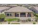 Aerial view of home showcasing lush landscaping, outdoor living space, and golf course community at 36172 N Secret Garden Path, Queen Creek, AZ 85140