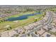 Gorgeous aerial view showcasing the community, lush golf course, scenic lake, and meticulously planned residential area at 36172 N Secret Garden Path, Queen Creek, AZ 85140