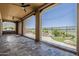 Spacious back porch with tile flooring, ceiling fans, and views of the golf course at 36172 N Secret Garden Path, Queen Creek, AZ 85140