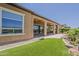 Backyard view with artificial grass, rock landscaping, and a view of the golf course at 36172 N Secret Garden Path, Queen Creek, AZ 85140