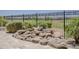 Backyard patio featuring a rock fountain with views of the community and golf course at 36172 N Secret Garden Path, Queen Creek, AZ 85140