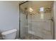 Beautiful bathroom with a shower featuring glass doors and tile accents with a tile floor at 36172 N Secret Garden Path, Queen Creek, AZ 85140