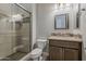 A stylish bathroom features a glass shower, decorative tile, and vanity with storage at 36172 N Secret Garden Path, Queen Creek, AZ 85140