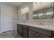 A spacious bath includes dual sinks, granite countertops, and elegant lighting at 36172 N Secret Garden Path, Queen Creek, AZ 85140