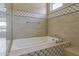 A luxurious tub with tile surround is ready for you to enjoy a relaxing bath at 36172 N Secret Garden Path, Queen Creek, AZ 85140