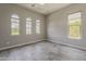 A bright bedroom features three windows, neutral walls, and neutral flooring at 36172 N Secret Garden Path, Queen Creek, AZ 85140